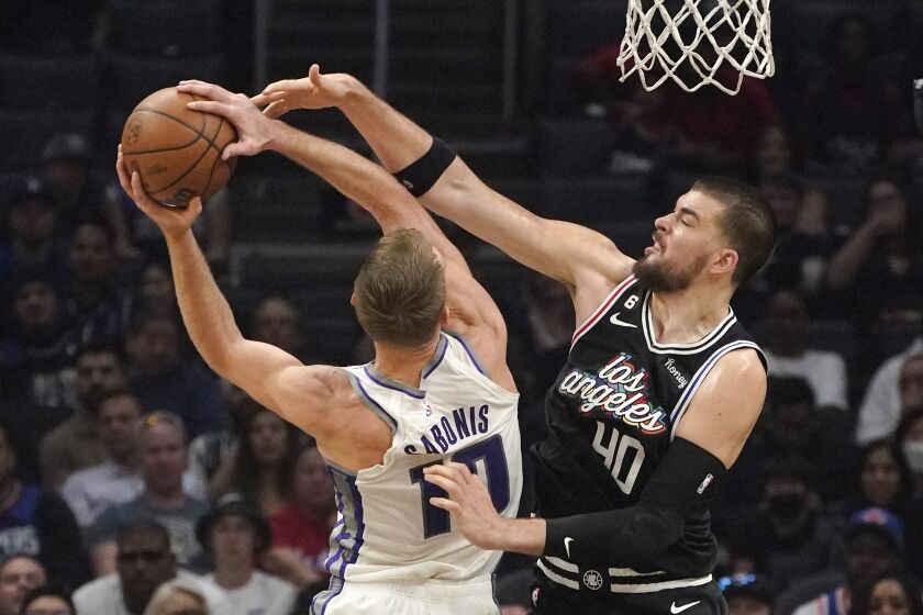 Sacramento Kings forward Domantas Sabonis, left, shoots as Los Angeles Clippers center Ivica Zubac defends during the first half of an NBA basketball game Saturday, Dec. 3, 2022, in Los Angeles. (AP Photo/Mark J. Terrill)