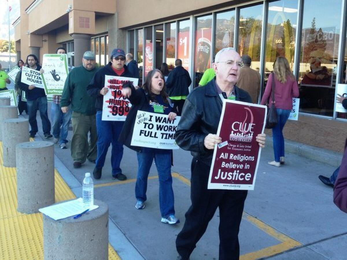 Protesters in front of the entrance to a Duarte Wal-Mart on Friday morning.