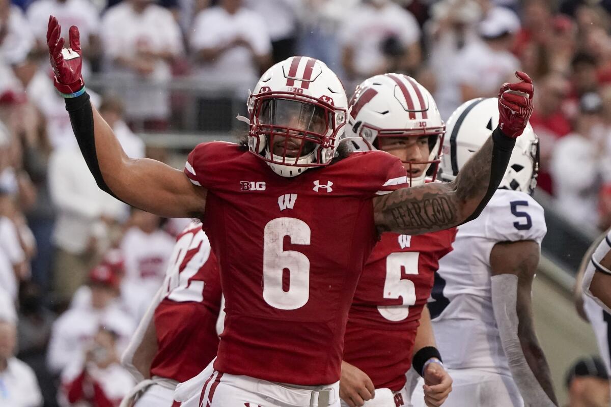 Wisconsin's Chez Mellusi celebrates his touchdown run during the second half of an NCAA college football game against Penn State Saturday, Sept. 4, 2021, in Madison, Wis. Penn State won 16-10. (AP Photo/Morry Gash)