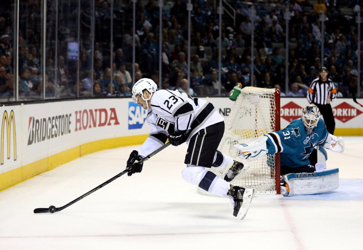Kings' Dustin Brown trips on the stick of San Jose goalie Martin Jones during Game 4 of the teams' first-round playoff series.