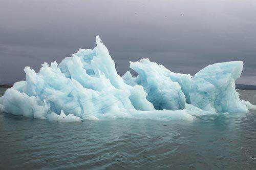 Sailing near the Arctic near Svalbard, Norway, offers a close look at glaciers and house-size chunks of ice that break off and take on blue, green or purple hues.