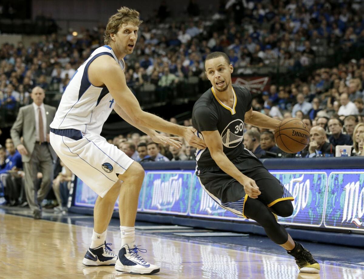 Golden State guard Stephen Curry, right, gets past Mavericks forward Dirk Nowitzki during Saturday's game in Dallas.