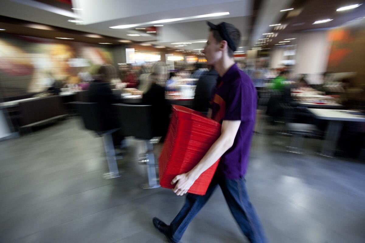 An employee carries trays in the McDonald's restaurant in Pushkin Square in Moscow.