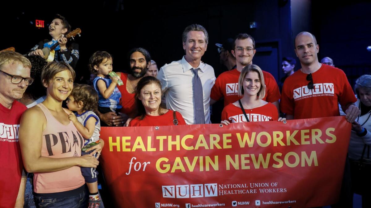 California Lt. Gov. Gavin Newsom, who is running for governor, takes a picture with supporters during a rally in Hollywood on June 3.