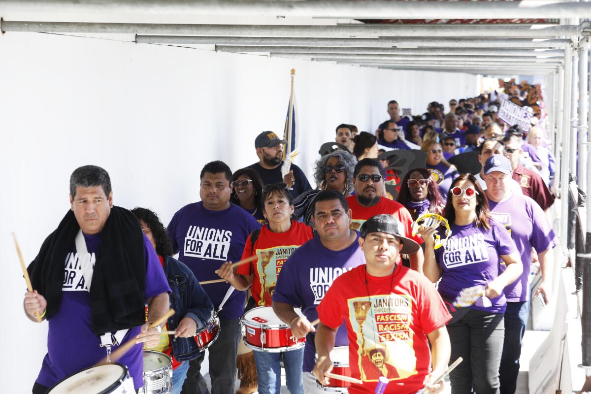 Workers marched through LAX last month for better pay and benefits.
