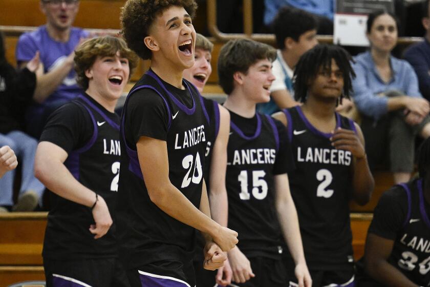 Carlsbad players celebrate after Carlsbad beat Torrey Pines in a high school basketball game Jan. 24, 2024, at Torrey Pines High School in San Diego, Calif. (Photo by Denis Poroy)