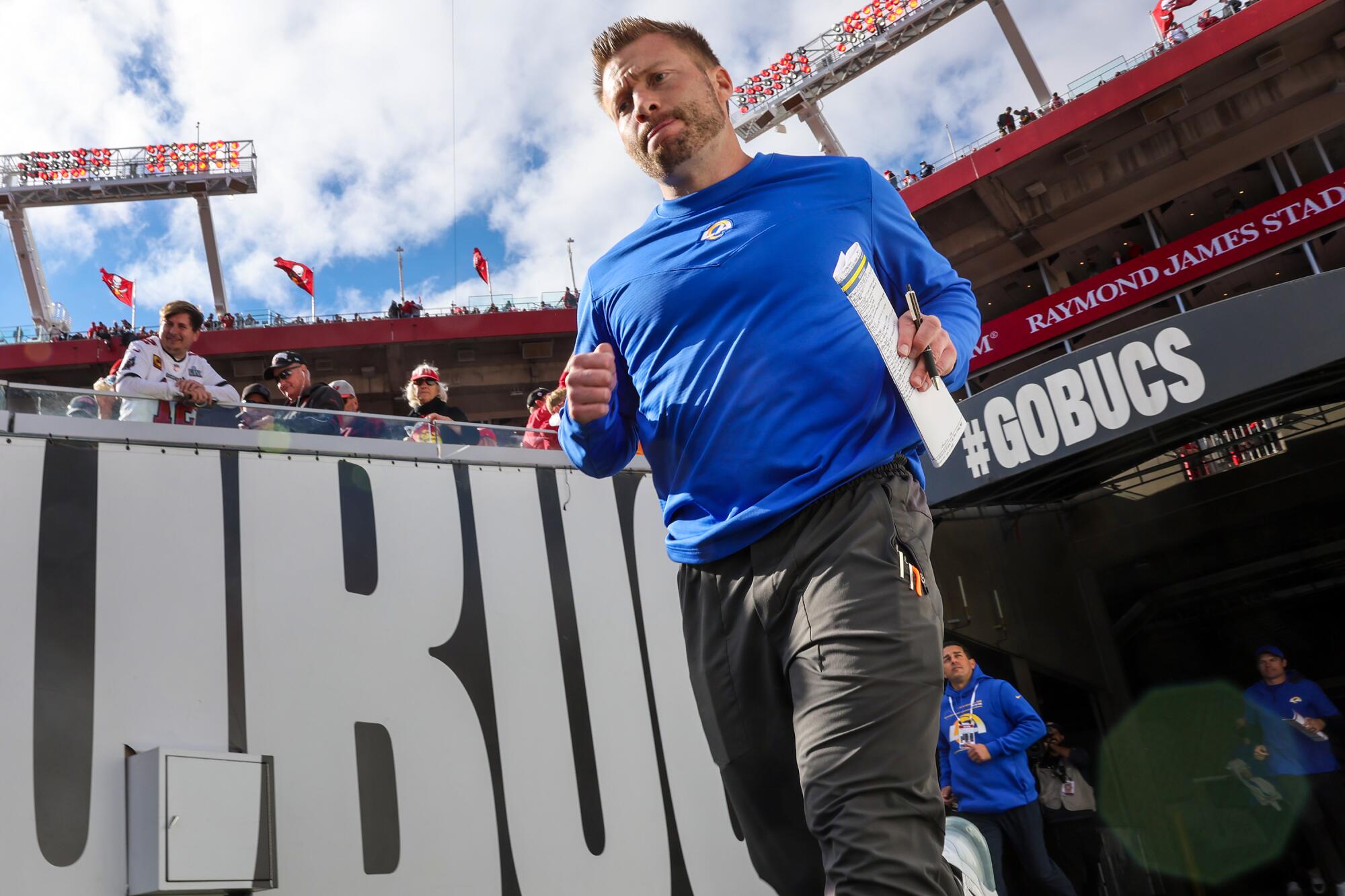 Rams coach Sean McVay runs onto the field before a playoff game against the Tampa Bay Buccaneers.