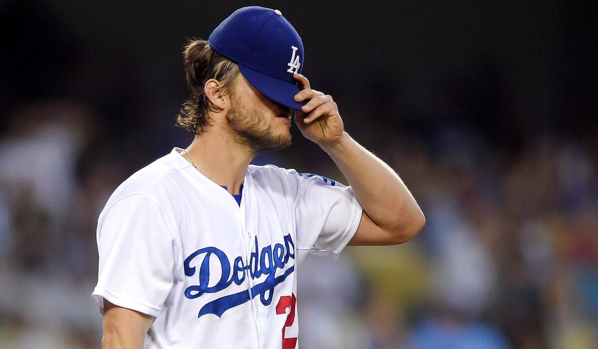 Los Angeles Dodgers starting pitcher Clayton Kershaw tips his hat down after giving up a two-run home run to Texas Rangers' Joey Gallo during the third inning on Wednesday.