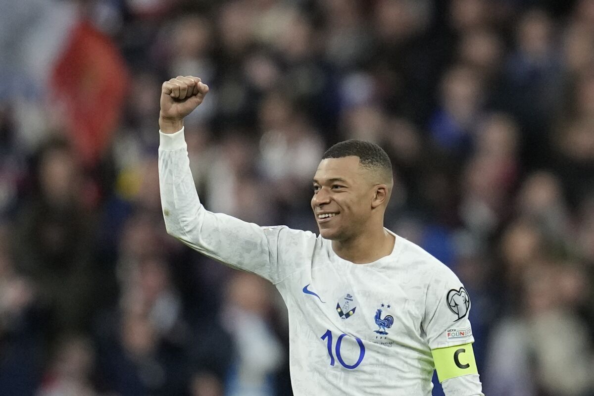 France's Kylian Mbappe celebrates after scoring his side's fourth goal during the Euro 2024 group B qualifying soccer match between France and the Netherlands at the Stade de France in Saint Denis, outside Paris, France, Friday, March 24, 2023. (AP Photo/Christophe Ena)