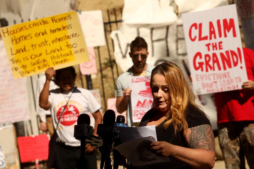 LOS ANGELES, CA - SEPTEMBER 23, 2022 - - Project Roomkey recipient Sonja Verdugo and resident at the LA Grand, tells her story during an unhoused tenants rally to demand dignified, permanent housing -- not evictions back to the street or inhumane shelter system -- in the face of the city's `demobilization' plan oustide the LA Grand along Figueroa Street in downtown Los Angeles on September 23, 2022. She was suppose to be evicted from the LA Grand but got an extension. "I should be gone by next week," she said. (Genaro Molina / Los Angeles Times)