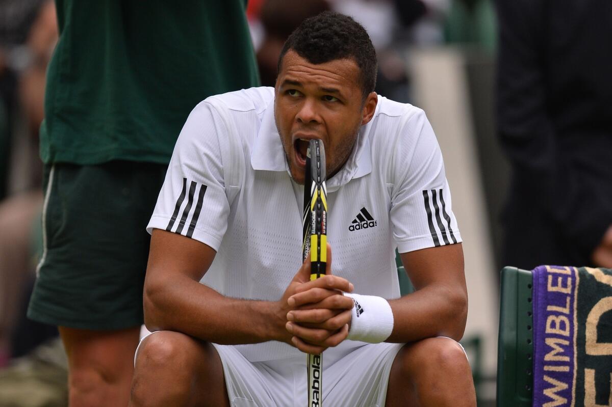 Jo-Wilfried Tsonga reacts after losing the second set against Latvia's Ernests Gulbis at Wimbledon on Wednesday.