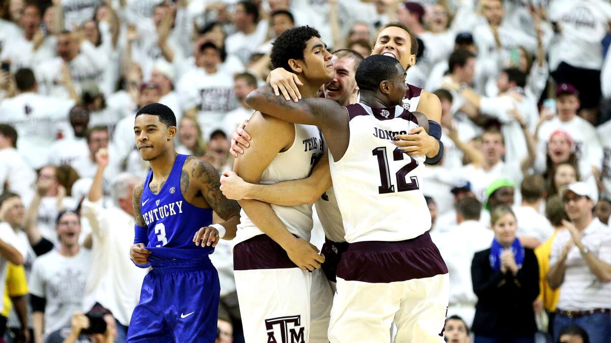 Texas A&M's Tyler Davis (left) celebrates his game-winning shot against Kentucky with teammates Saturday night.