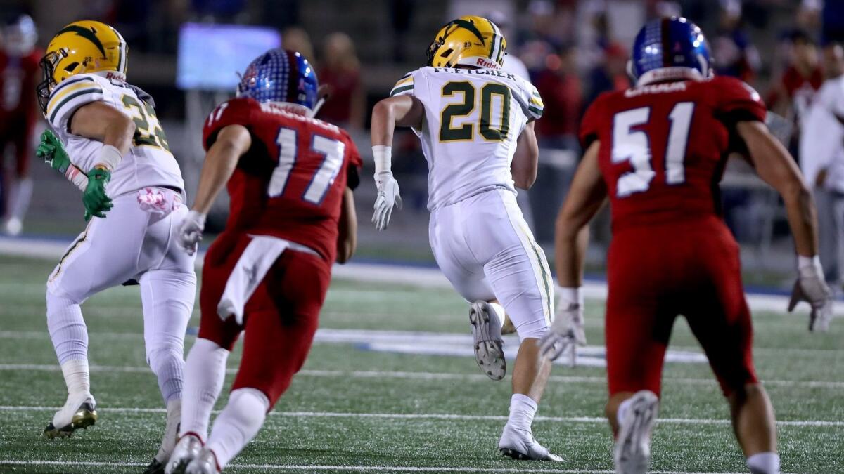 Edison High's Trent Fletcher (20) returns an interception 90 yards for a touchdown in a Sunset League game against Los Alamitos at Cerritos College in Norwalk on Oct. 26.