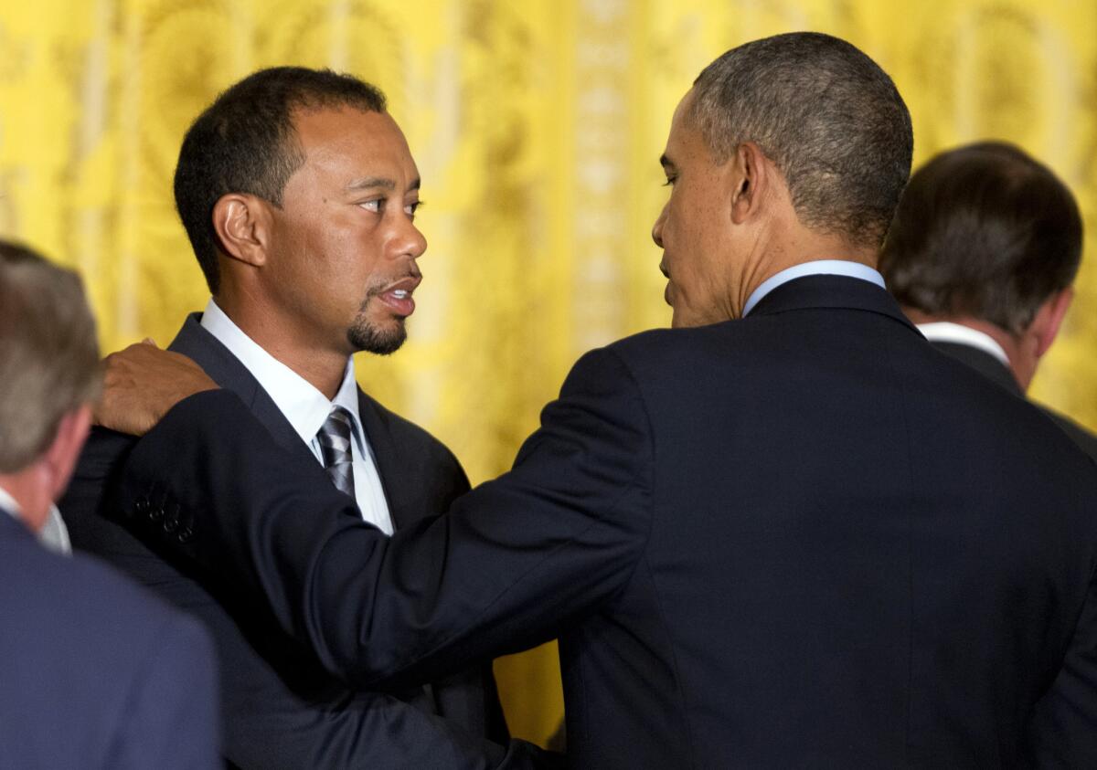 President Obama talks to Tiger Woods and other members of the 2013 Presidents Cup teams Tuesday during a ceremony at the White House.