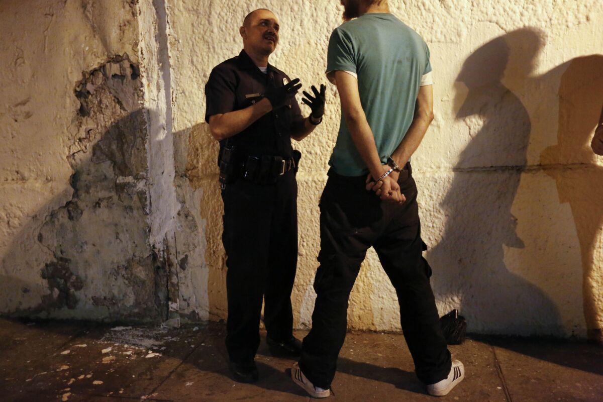 Officer Jose Ibarra questions a homeless man on probation in Silver Lake.