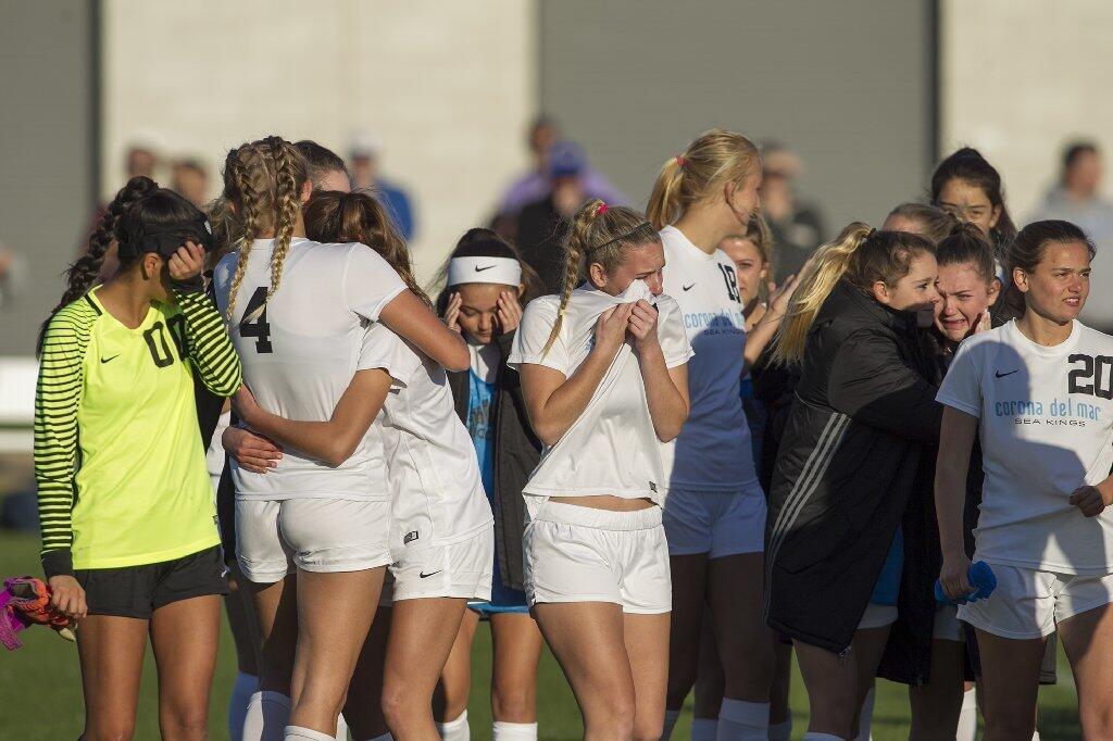 Corona del Mar High players console each other after losing in the quarterfinals of the CIF Southern Section Division 2 playoffs.