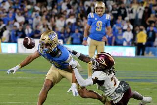 Pasadena, CA - UCLA wide receiver Logan Loya can't hang on to a pass from quarterback Colin Schlee.
