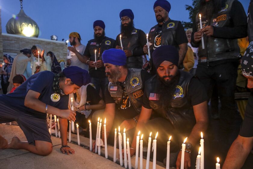 Oak Creek, WI - August 05: Members of Sikh Motorcycle Club travelled cross-country from Stockton light candles at candlelight vigil held to commemorate the 10th. anniversary of mass shooting at Sikh Temple of Wisconsin on Friday, Aug. 5, 2022 in Oak Creek, WI. (Irfan Khan / Los Angeles Times)