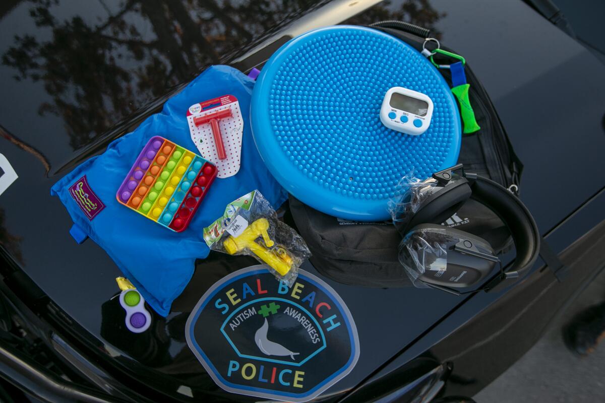 A sensory kit includes headphones, fidget toys, a weighted blanket and other items used to help individuals with autism.