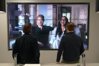 Office workers in London, watch the Duke and Duchess of Sussex's controversial documentary being aired on Netflix Thursday, Dec. 8, 2022. Britain’s monarchy is bracing for more bombshells to be lobbed over the palace gates as Netflix releases the first three episodes of a new series. The show “Harry & Meghan” promises to tell the “full truth” about Prince Harry and his wife Meghan’s estrangement from the royal family. The series debuted Thursday. (Jonathan Brady/PA via AP)