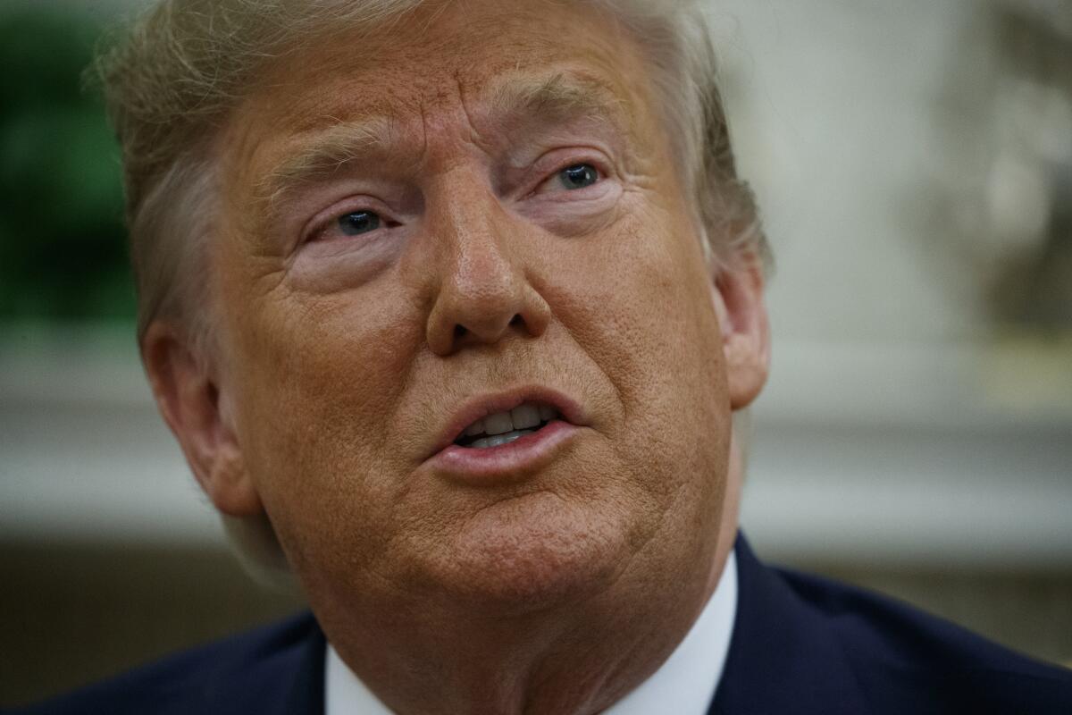 President Trump speaks to reporters in the Oval Office on Friday.