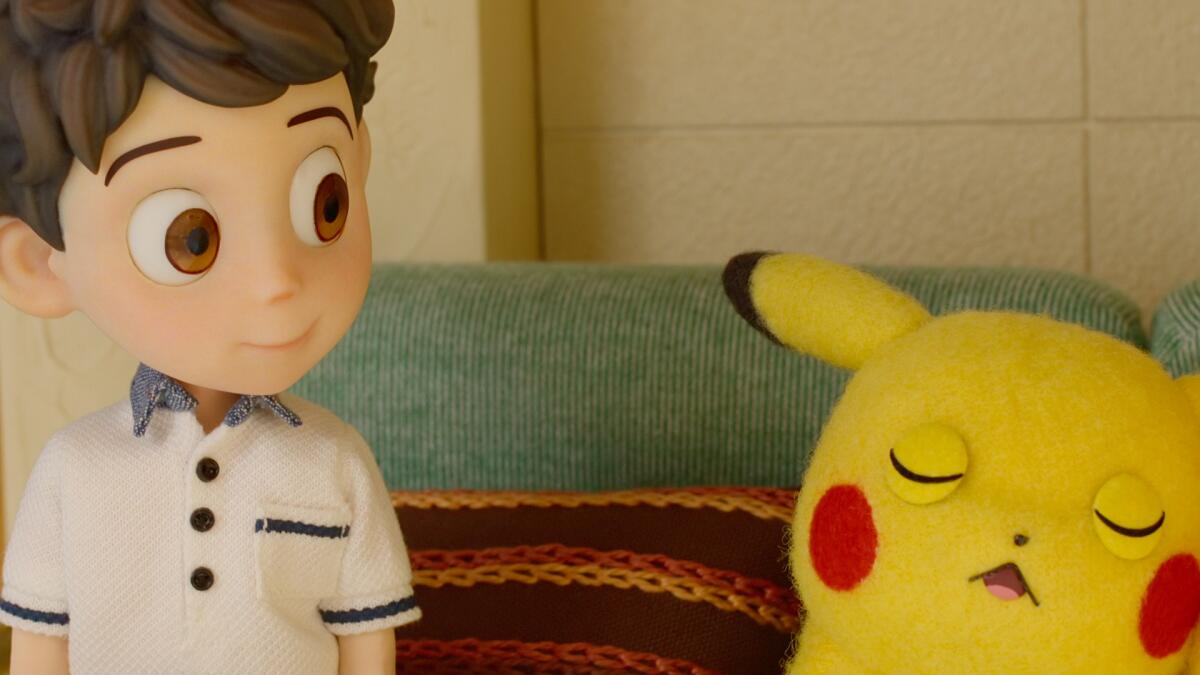 An animated boy looks on as Pikachu naps.