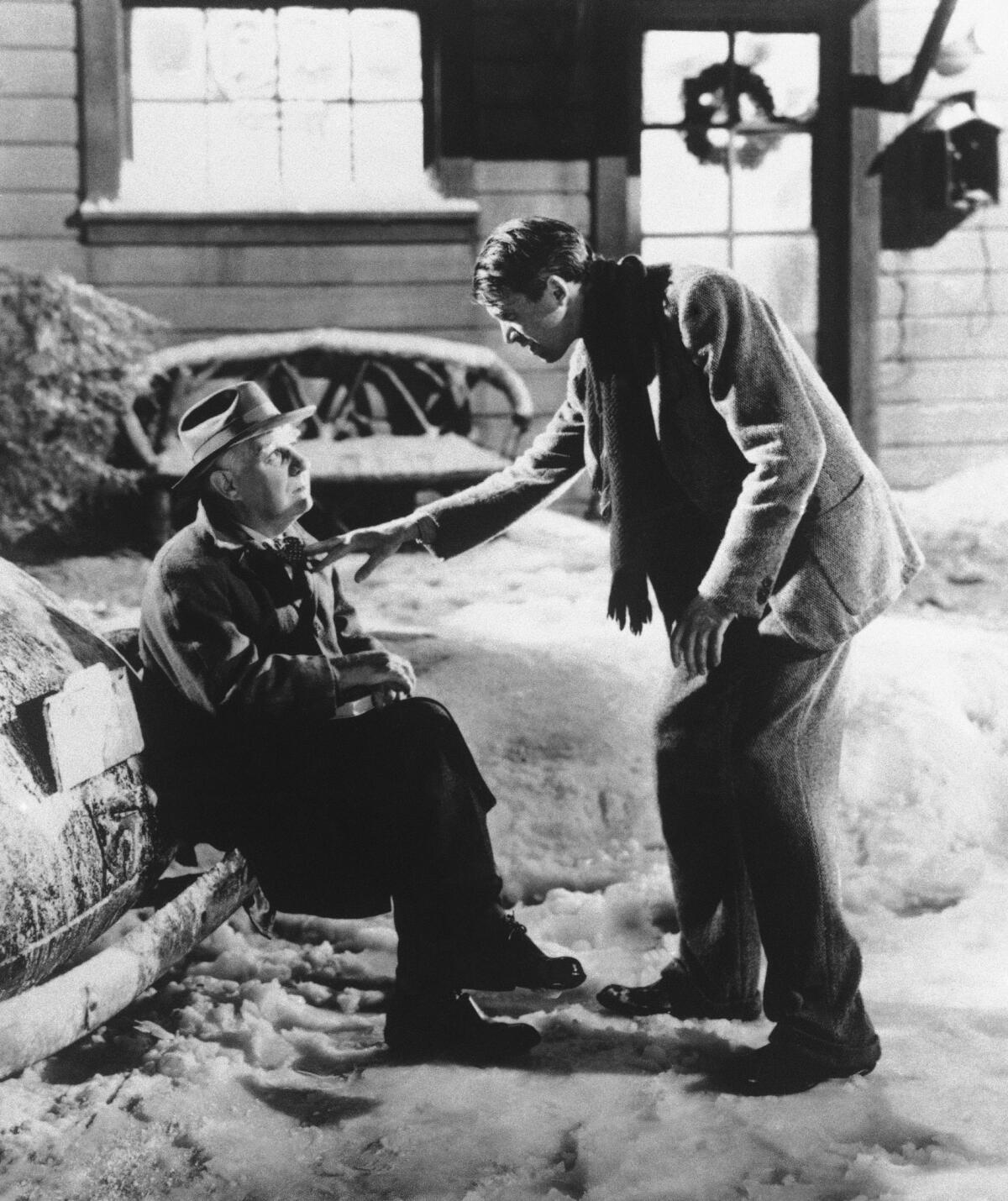 James Stewart, right, playing George Bailey in a scene opposite Henry Travers as Clarence the Angel in the 1946 film "It's a Wonderful Life."