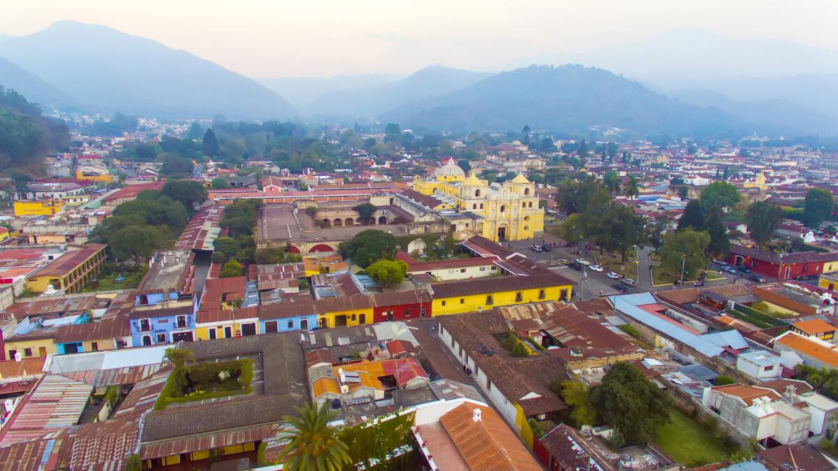 Elevated view of Antigua, Guatemala, at twilight. Antigua is a partially restored colonial city with majestic churches and monasteries and cobblestone streets.
