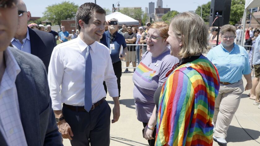 Democratic presidential candidate Pete Buttigieg talks with attendees at Capital City Pride Fest in Des Moines on June 8.