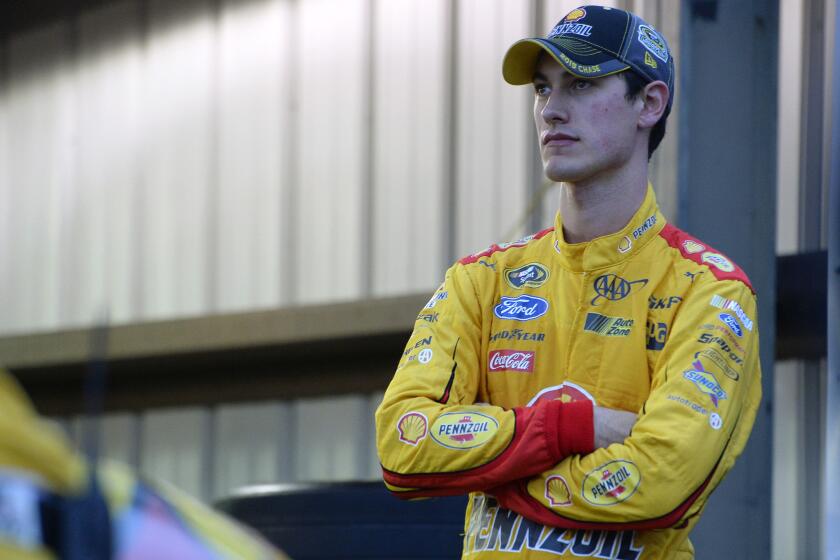 Matt Kenseth stands in the garage during the NASCAR Sprint Cup Series Goody's Headache Relief Shot 500 at Martinsville Speedway on Sunday.