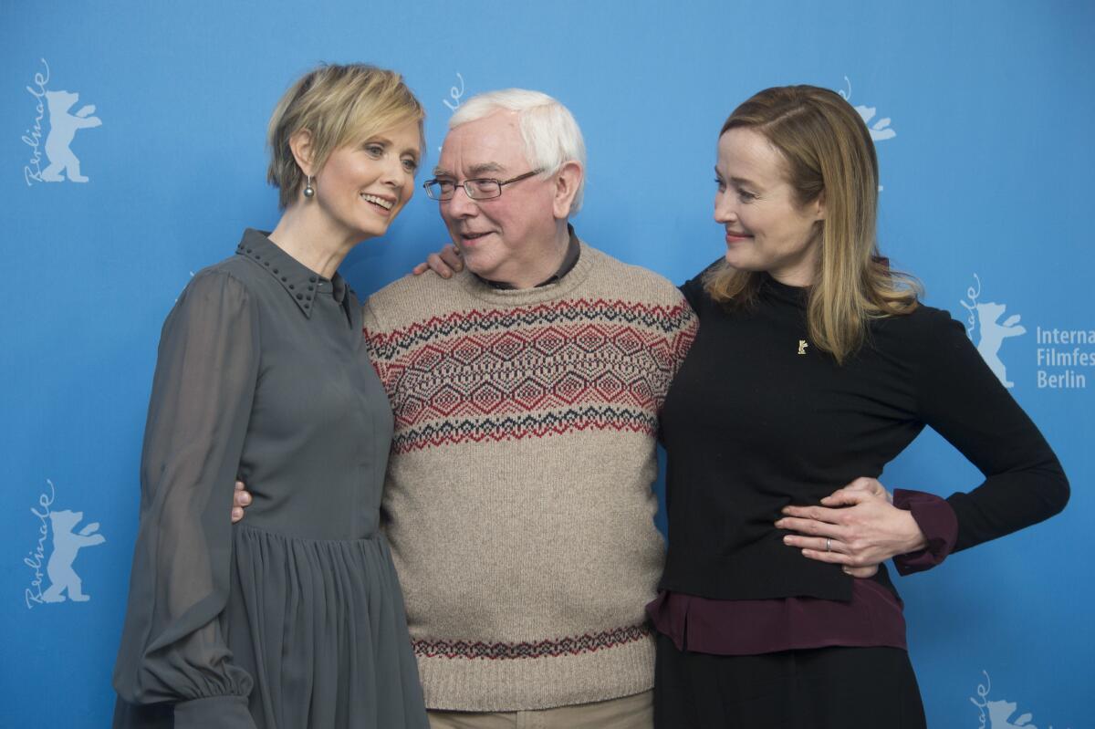 Three movie colleagues pose for the camera.