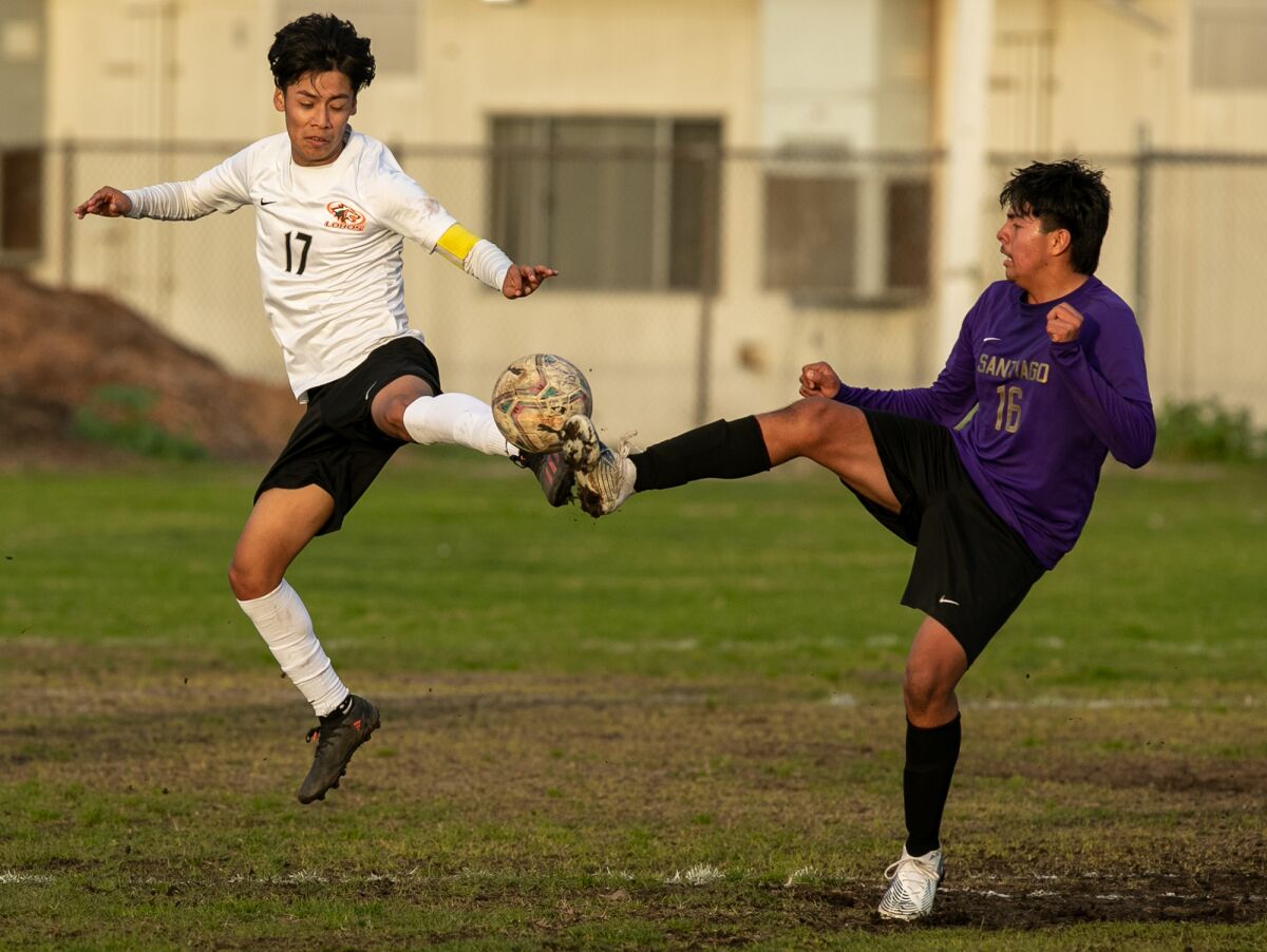 Los Amigos' Anthony Gutierrez and Santiago's Fabian Barajas battle for the ball in a youth soccer match in the Garden Grove League.