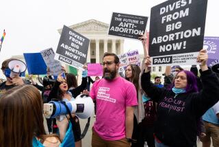 UNITED STATES - MAY 3: Pro-life activists surround a man wearing a Planned Parenthood shirt during their rally in front of the U.S. Supreme Court on Tuesday, May 3, 2022, after a leaked draft opinion indicated the court will overturn Rove v. Wade. (Bill Clark/CQ-Roll Call, Inc via Getty Images)