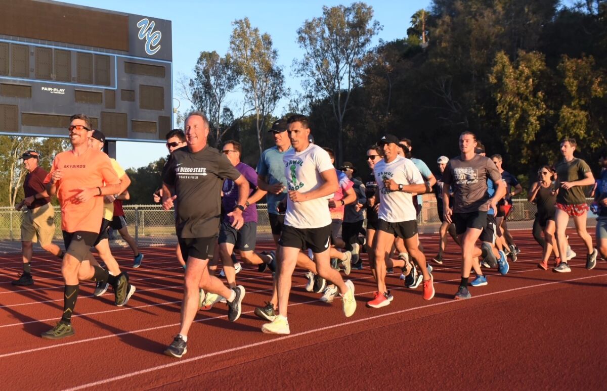 Paul Greer, in black T-shirt in front, runs his "final mile" with S.D. Track Club and others before hip replacement surgery.