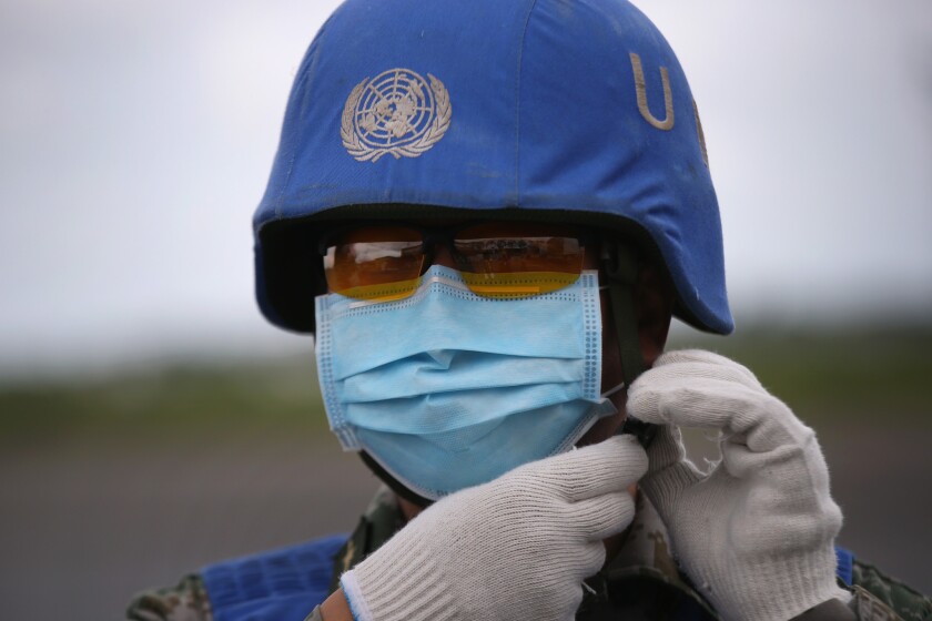 A United Nations soldier from China prepares a truckload of Ebola aid in Harbel, Liberia, on Aug. 23.