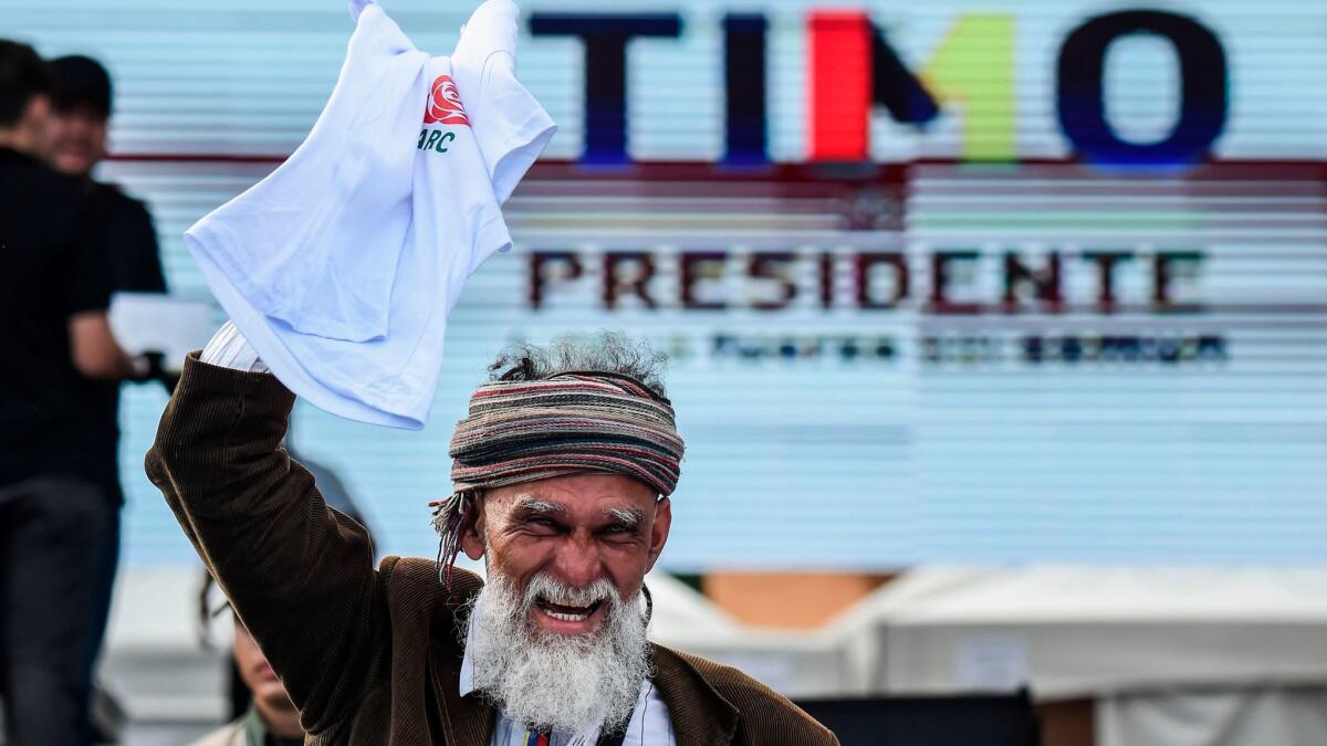 A man takes part in the launch of the political campaign for president of FARC leader Rodrigo Londono Echeverri, known as "Timochenko," on Saturday in Bogota, Colombia.