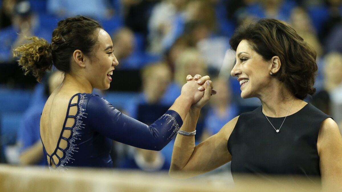 Katelyn Ohashi and coach Valorie Kondos-Field share a moment during a meet against Stanford at Pauley Pavilion on March 10, 2019.