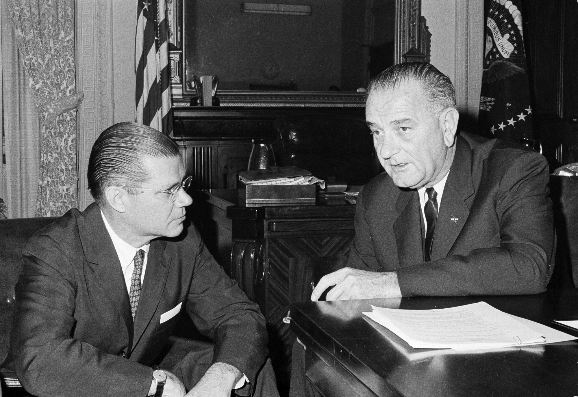 President Lyndon B. Johnson confers with Secretary of Defense Robert McNamara in Washington on Nov. 23, 1963.