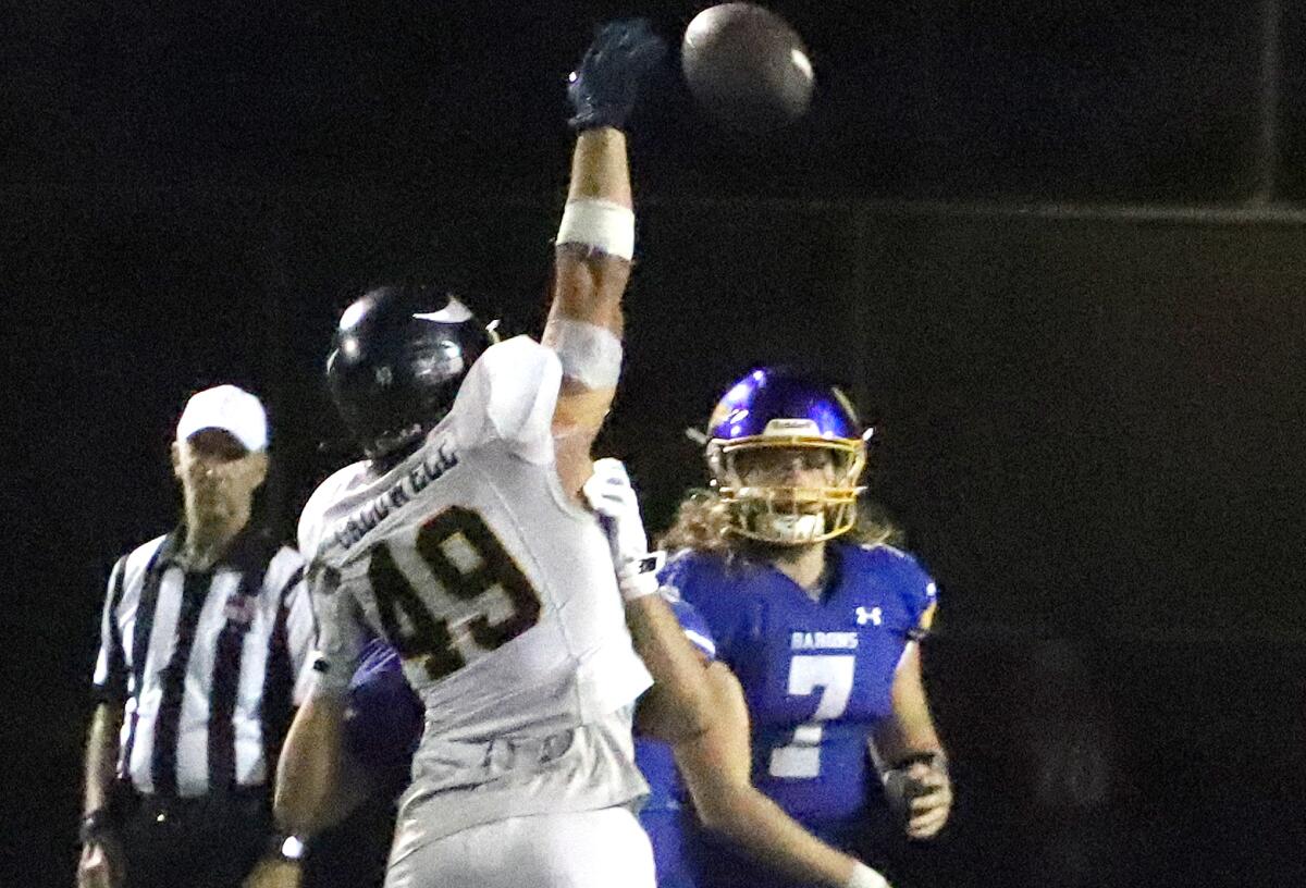 Marina's Duk Caldwell (49) tries to bat down a pass from Fountain Valley's Lucas Alexander (7) in a nonleague game on Friday.