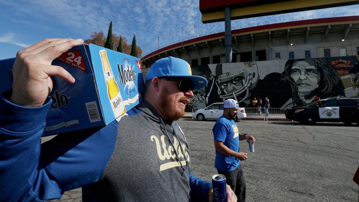 UCLA football fans arrive with refreshments before a game against the USC Trojans.