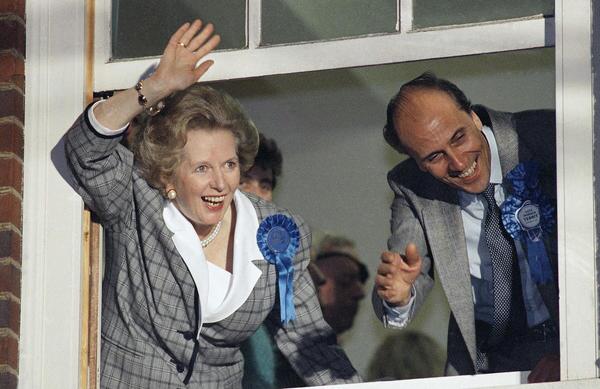 British Prime Minister Margaret Thatcher waves to supporters from Conservative Party headquarters in London after claiming victory in Britain's general election in June 1987.