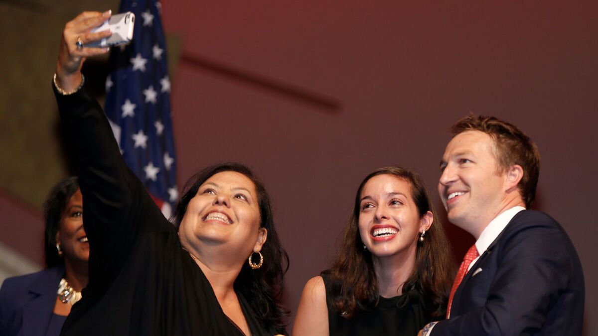 Los Angeles school board members Monica Garcia, left, Kelly Gonez and Nick Melvoin pose for a photo during their swearing-in ceremony at the Cortines School of Visual and Performing Arts in Los Angeles.