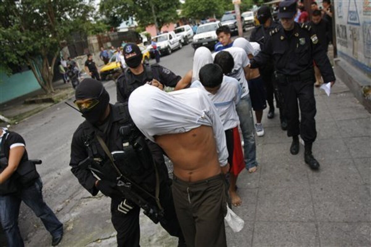 Police present to the press eight suspects in connection with the burning of a bus that killed 14 after detaining them in San Salvador, Monday, June 21, 2010. Gang members opened fire on a bus full of travelers on Sunday night, doused it with gasoline and set it on fire, killing at least 14 on the outskirts of El Salvador's capital, officials said Monday. (AP Photo/Luis Romero)