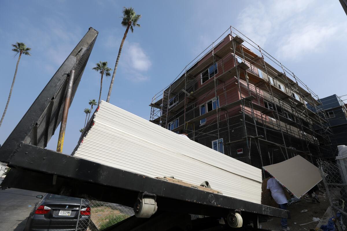 Building material on a truck is delivered to a housing construction site