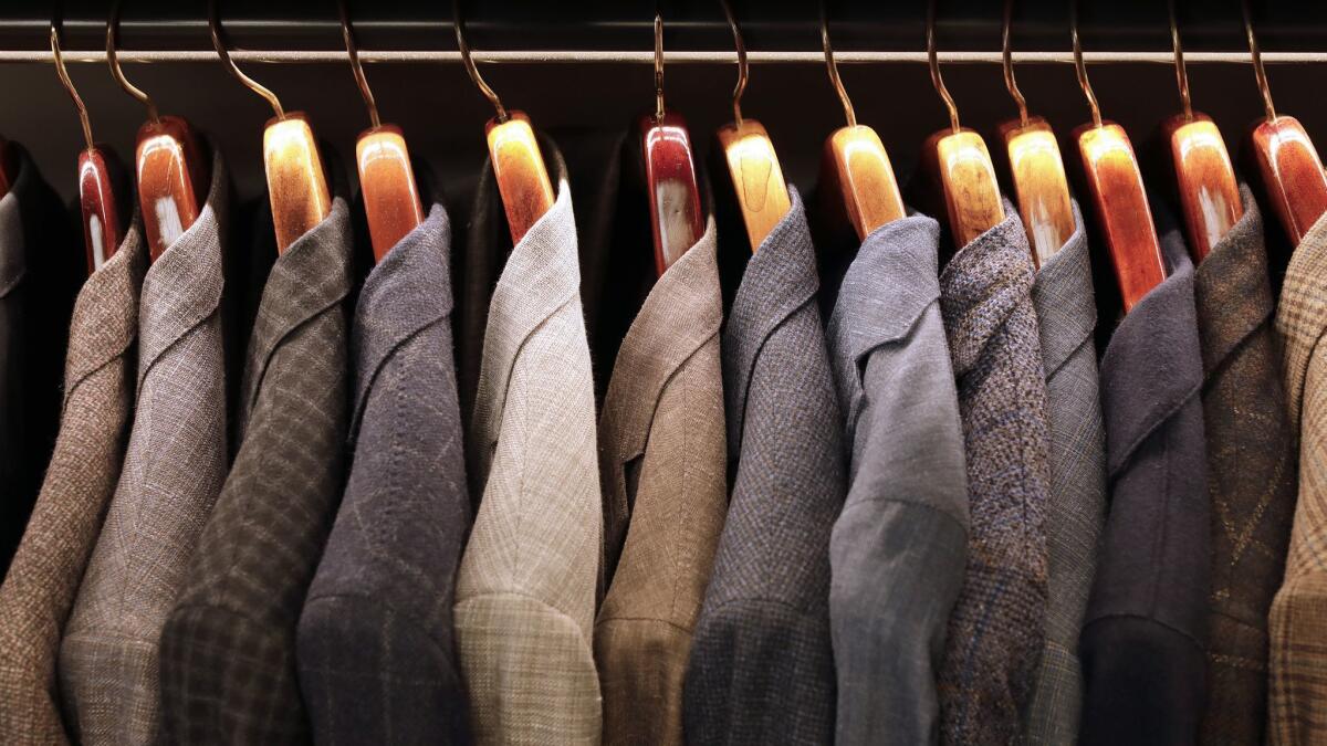 Men's jackets line a rack at Carroll & Co.