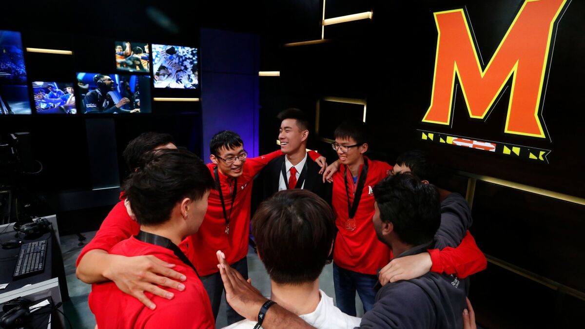 Members of the "League of Legends" team from the University of Maryland huddle after their sweeping victory over the University of Illinois in the Big Ten Network "League of Legends" championship at the Battle Theater in Los Angeles on March 27.