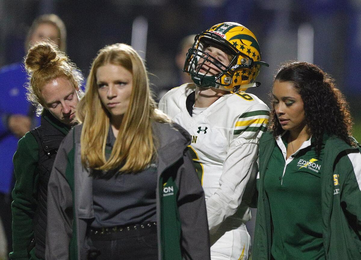 Edison quarterback Braeden Boyles is helped off of the field by trainers after being injured during a pass play against La Habra in the quarterfinals of the CIF Southern Section Division 3 playoffs on Friday.