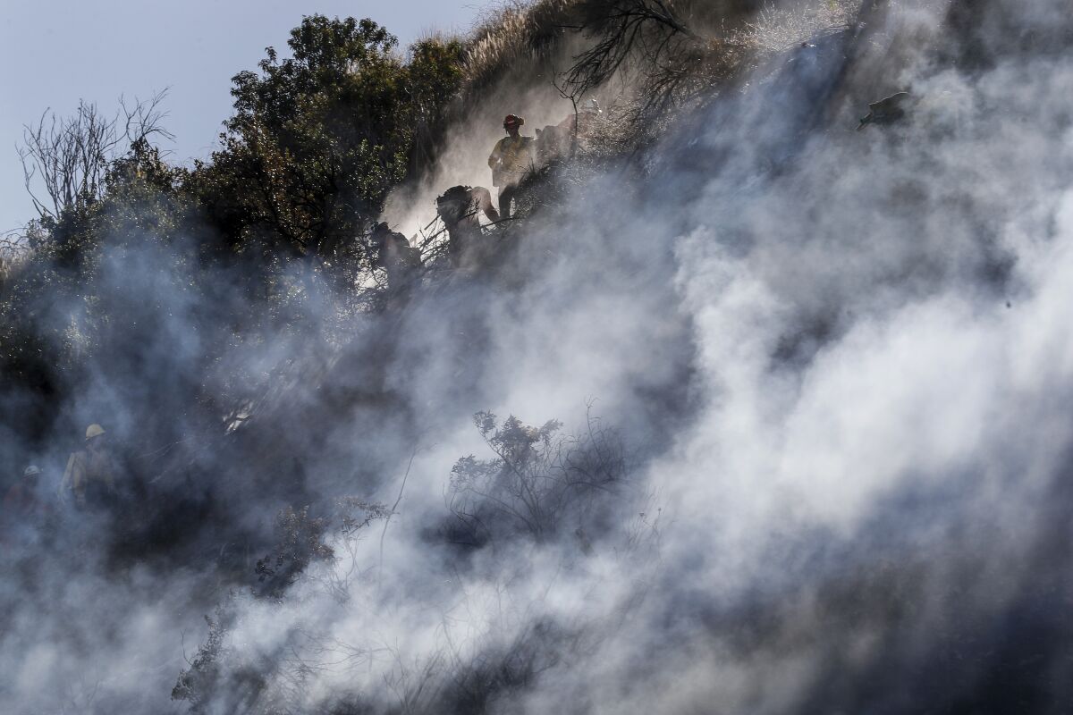 Firefighters amid wildfire smoke