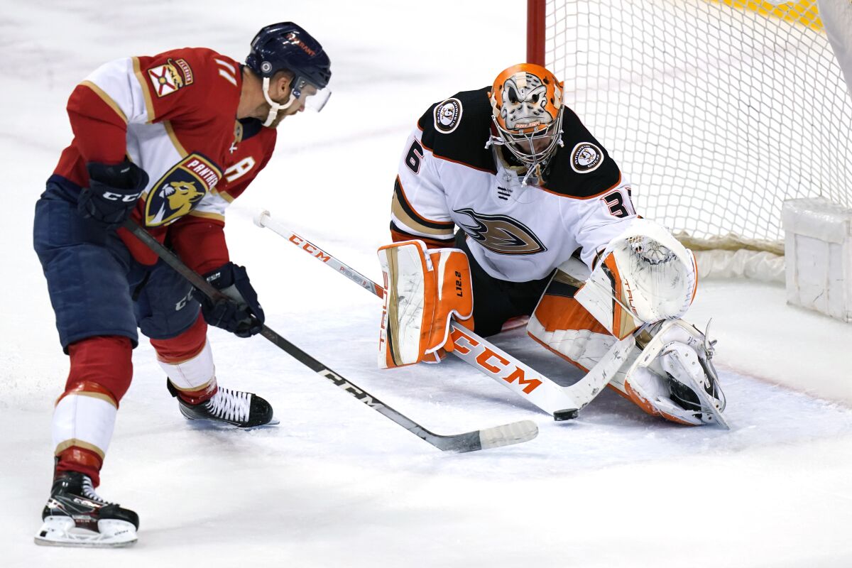 Florida Panthers left wing Jonathan Huberdeau (11) sets up a shot to score a goal against Anaheim Ducks goaltender John Gibson during overtime in an NHL hockey game, Tuesday, April 12, 2022, in Sunrise, Fla. The Panthers won 3-2. (AP Photo/Lynne Sladky)
