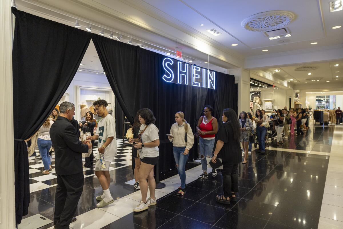 Shoppers line up outside Shein's pop-up store at the Ontario Mills mall